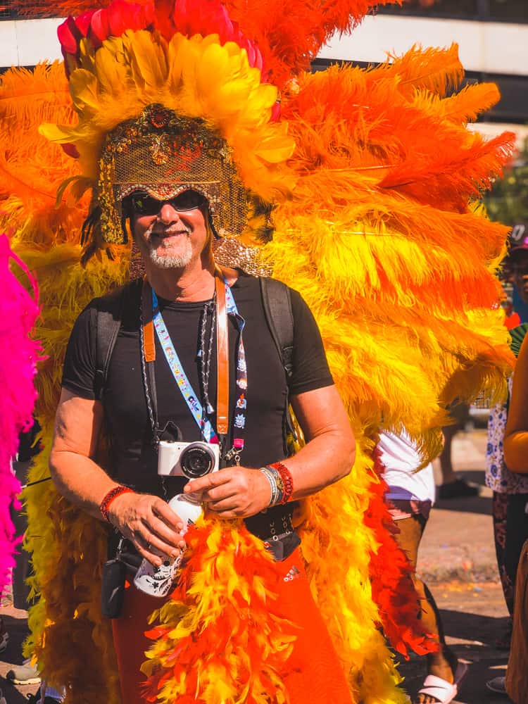 Getting to Notting Hill Carnival 1 man wearing a headdress gown at notting hill