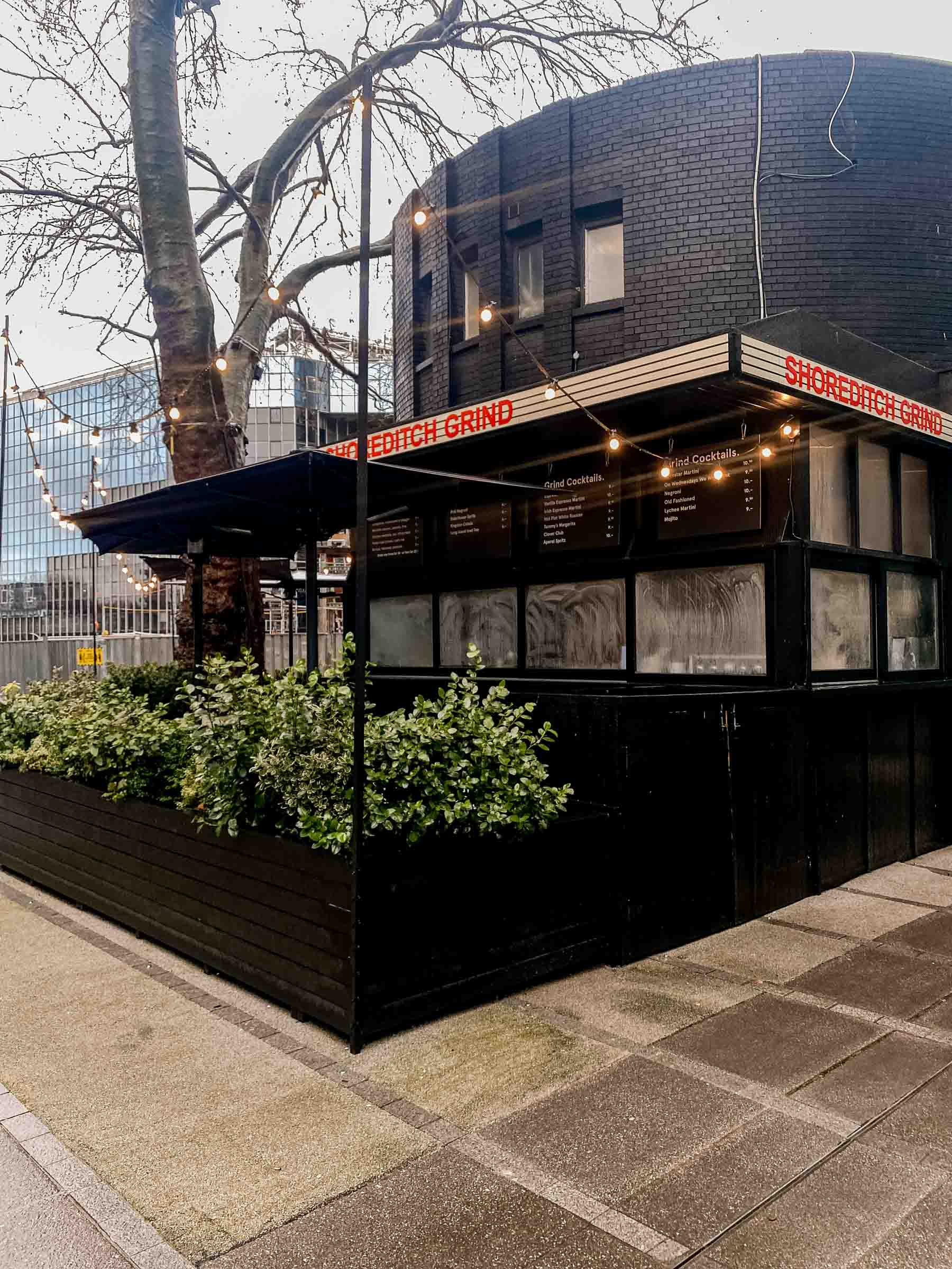 The Shoreditch grind coffeee roaster entrance before opening on a cloudy day in London. 