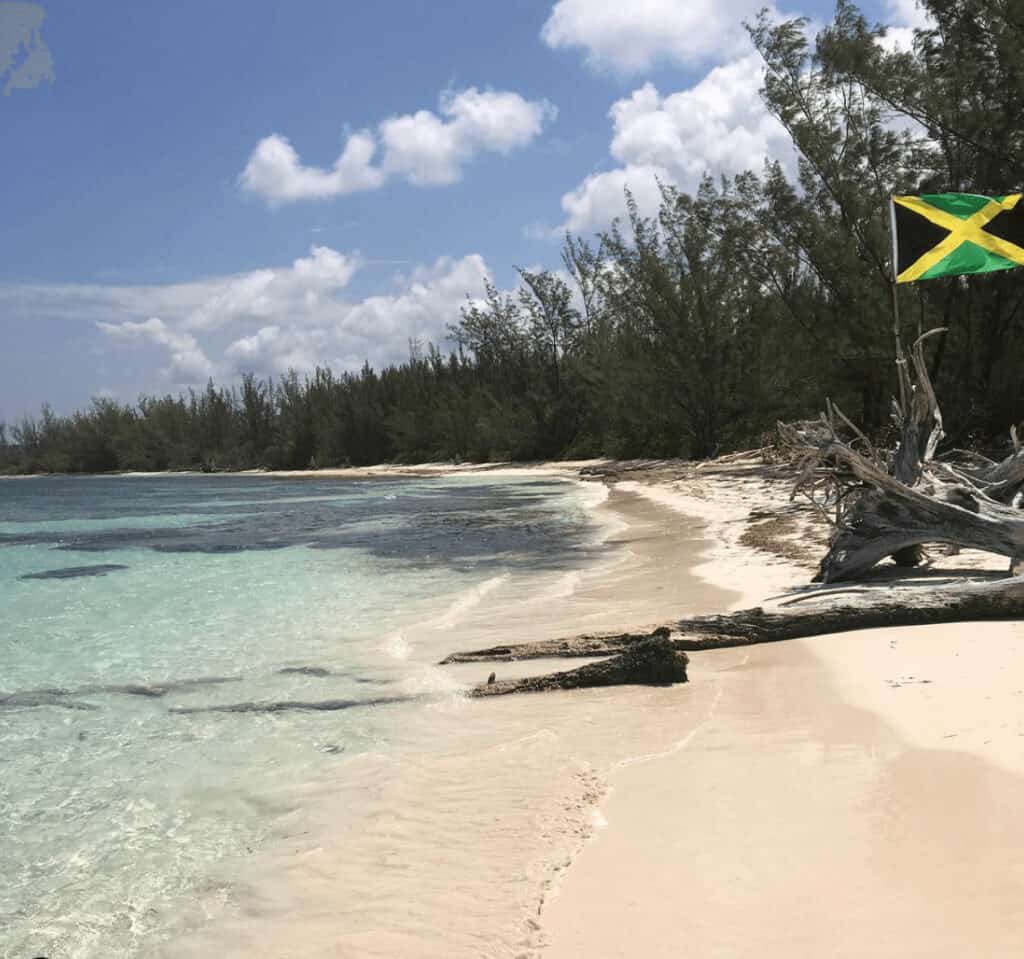 Red Stripe Beach Jamaica Jamaican flag flying in the wind on Red Stripe Beach Jamaica