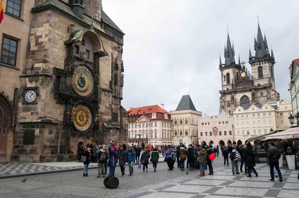 Tourists visiting the Old Town square at the Prague city cente Tourists visiting the Old Town square at the Prague city cente
