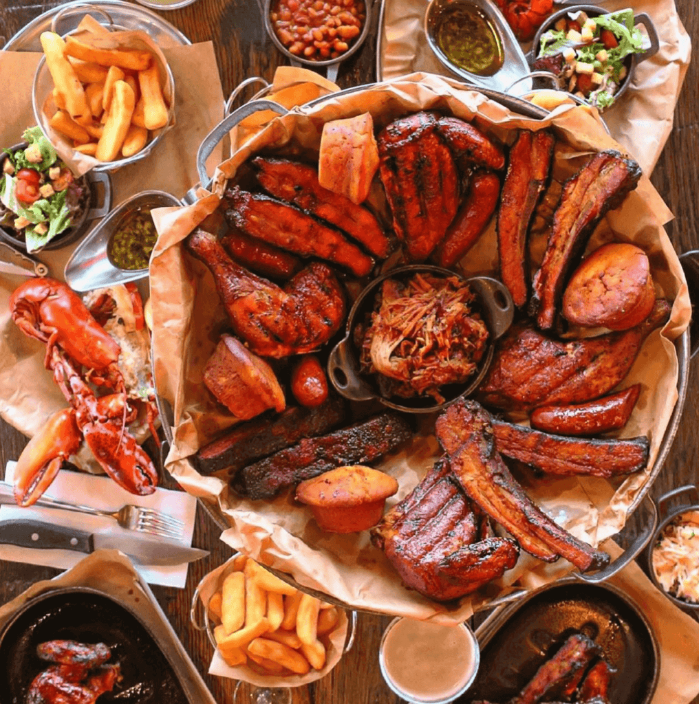 Big Easy BBQ Covent Garden Big Easy BBQ Covent Garden full spread of BBQ chicken, pulled pork, lobster, cornbread, beans and salad