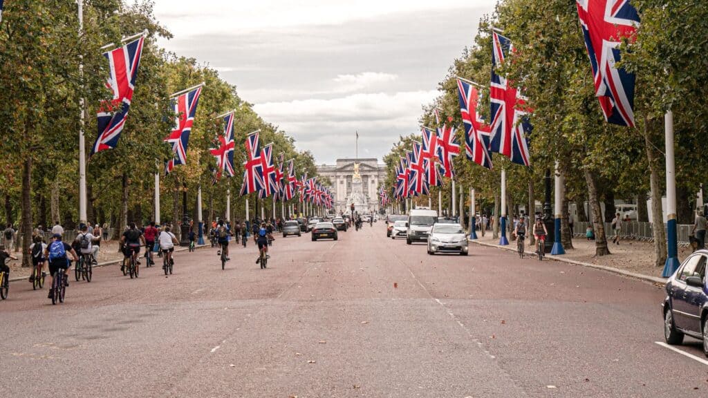 Buckingham Palace in london cyclists riding along the Mall in London