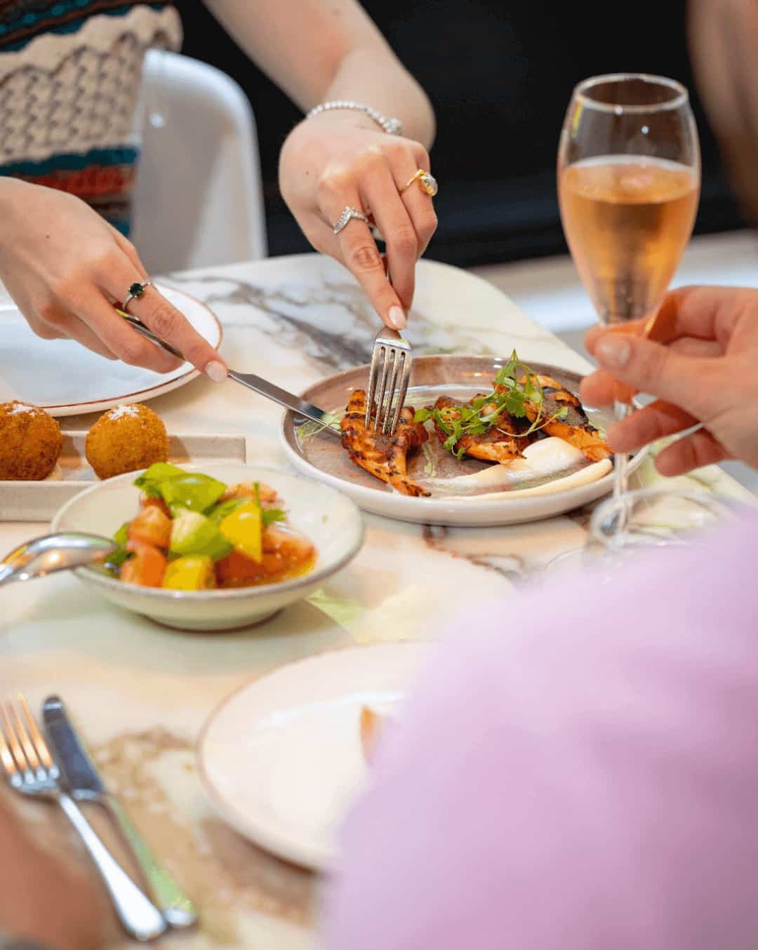 Monmouth Kitchen Monmouth Kitchen London people sharing a glass of wine and chicken