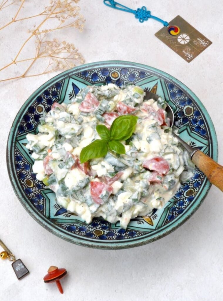 cottage cheese salad with cucumber, tomatoes and fresh herbs