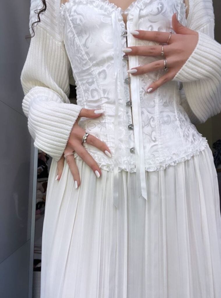 corset top + pleated white skirt + knit bolero