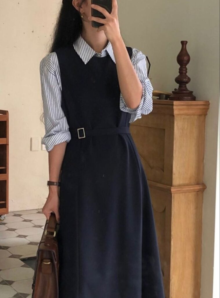 striped blouse + navy sleeveless dress + leather bag