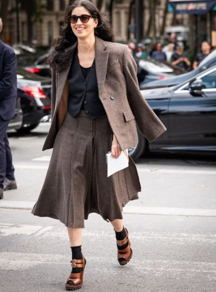 brown oversized blazer + black vest + pleated midi skirt + brown platform sandals