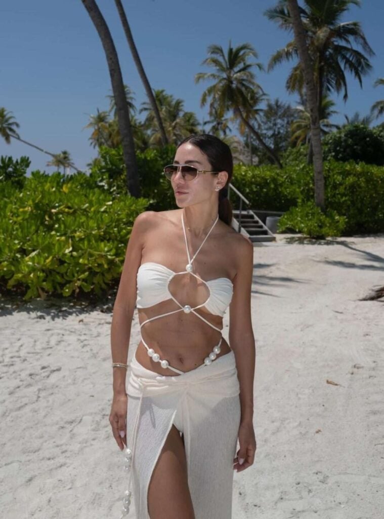 pearl-strap bikini + slit skirt + aviators