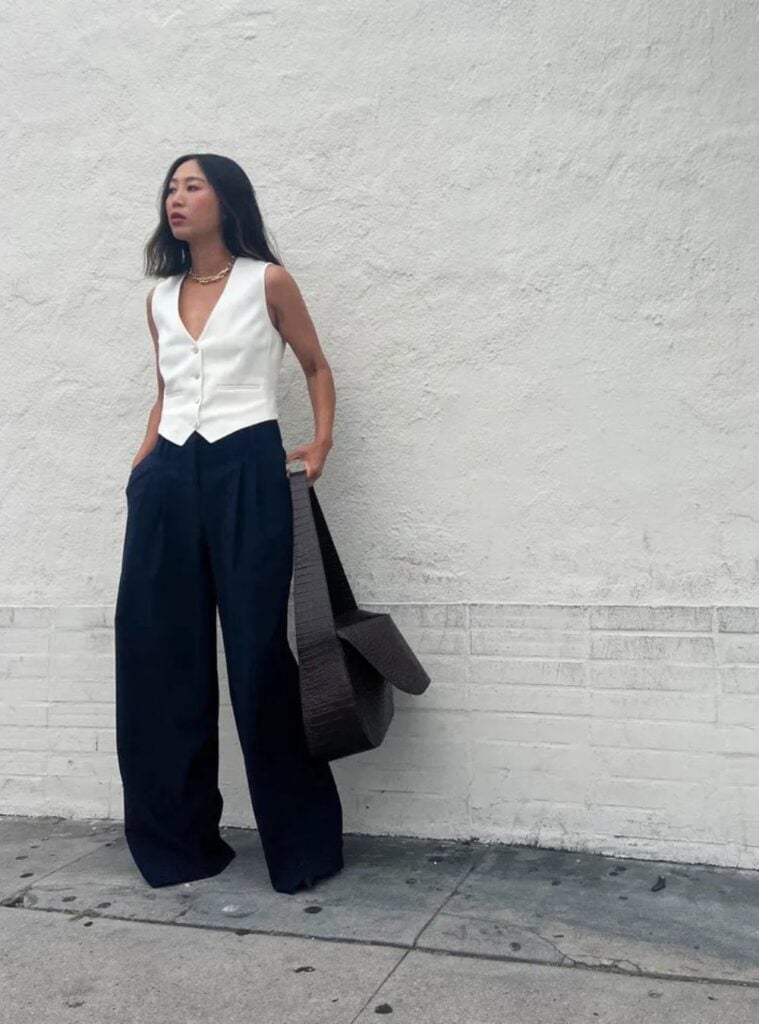 white vest + navy wide-leg trousers + chunky bag