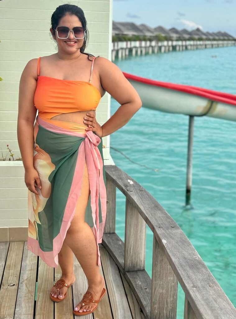 one-shoulder swimsuit + printed sarong + slides