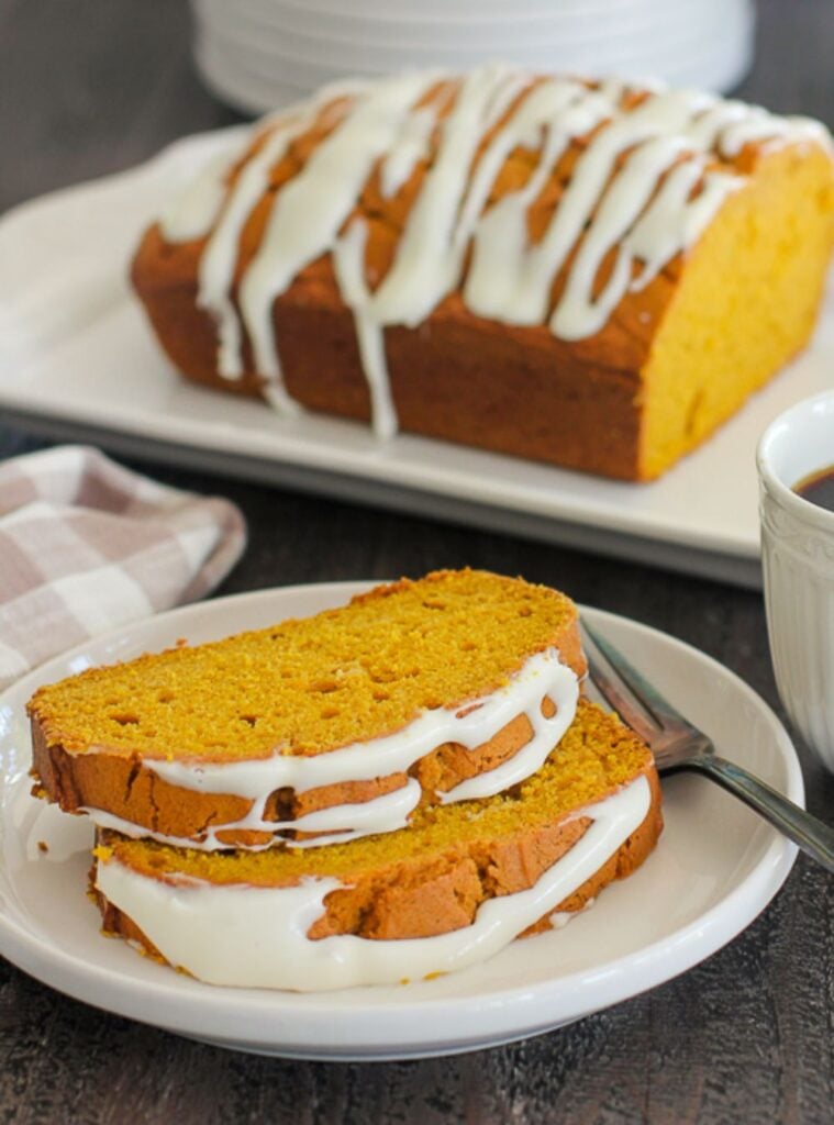 loaf of pumpkin bread topped with cream cheese frosting, perfect for fall brunch ideas