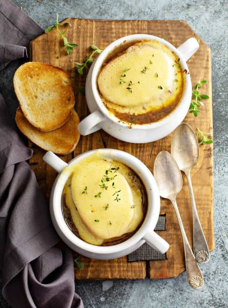 french onion soup topped with bread and cheese, fall crockpot recipe for soup lovers