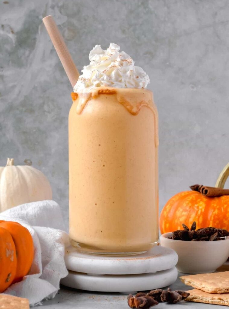 pumpkin protein shake in a glass with cinnamon sprinkle, energizing healthy fall breakfast idea