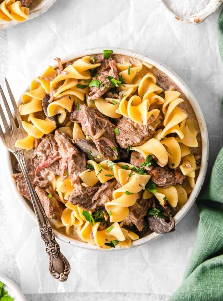 beef stroganoff with noodles cooked in crockpot, classic fall dinner recipe