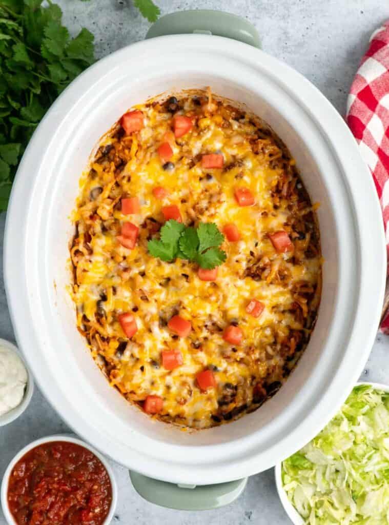 Flavorful crockpot taco casserole topped with melted cheese for an easy, crowd-pleasing meal.