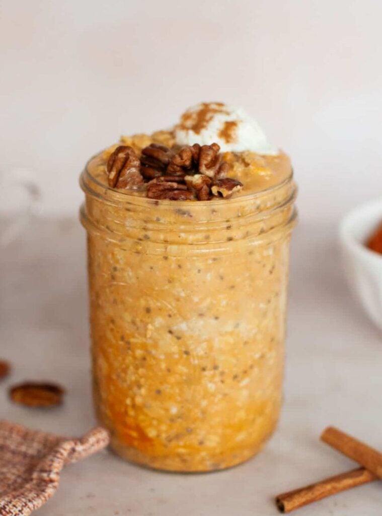 jar of creamy pumpkin overnight oats topped with nuts, an easy pumpkin recipe