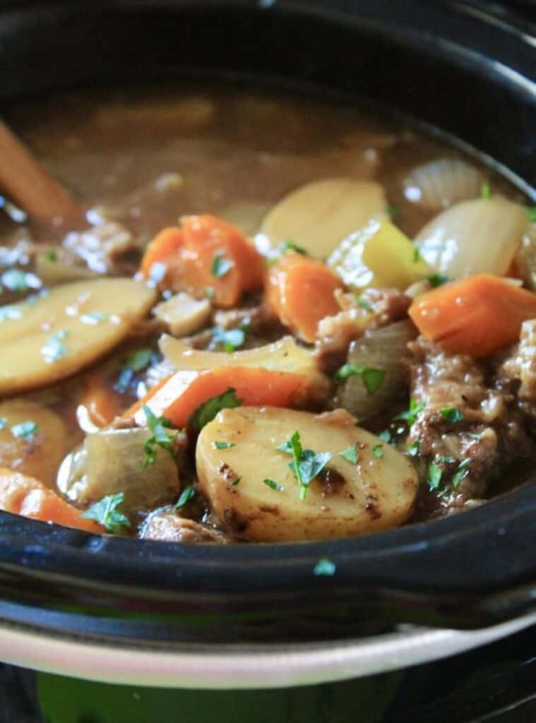 beef stew with red wine and vegetables in crockpot, hearty fall crockpot meal