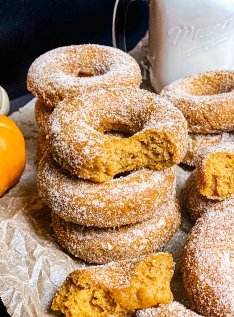 soft baked donuts coated in sugar, satisfying pumpkin treats