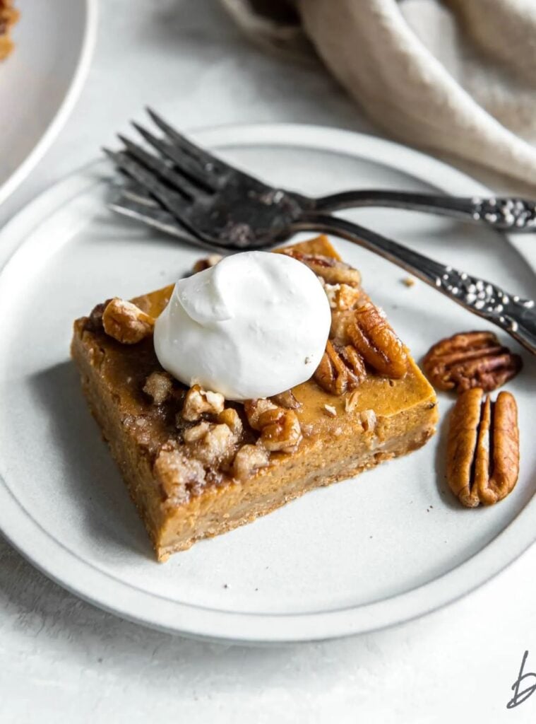 layered pumpkin pie desserts with pecan topping and shortbread crust