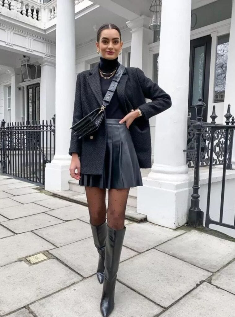 17 Black Tweed Blazer Black Turtleneck Black Pleated Faux Leather Skirt Polka Dot Tights Black Knee High Boots office christmas party outfit for women tweed blazer leather skirt