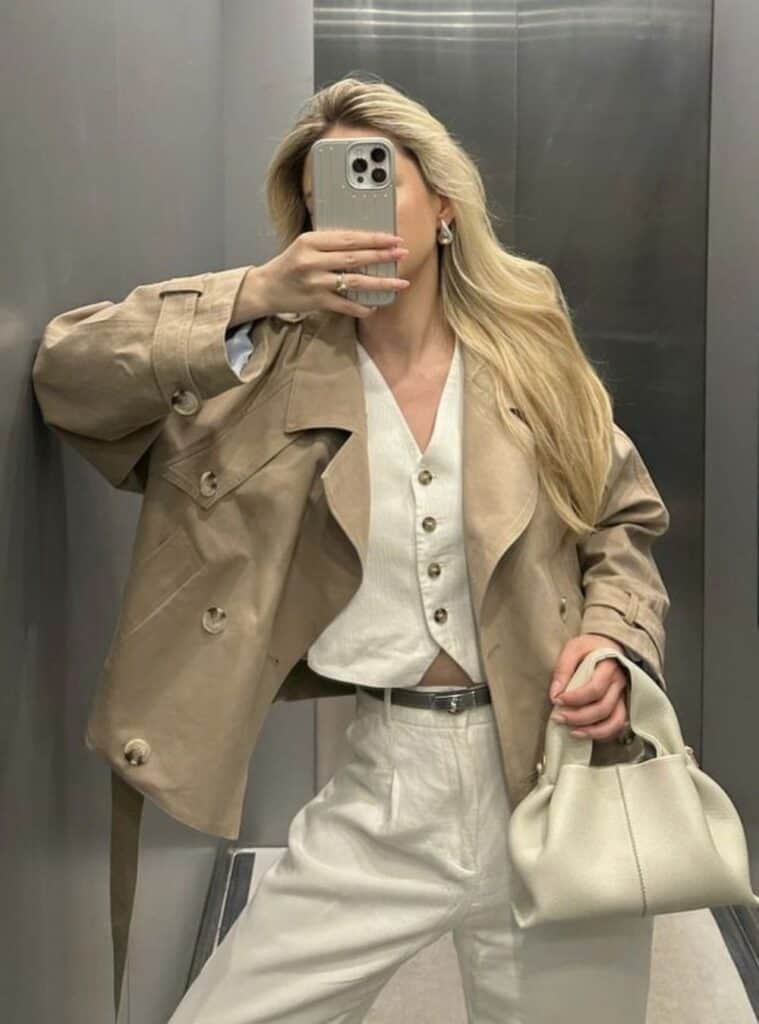 22 Khaki Trench Coat White Button Up Vest White Pleated Trousers White Leather Handbag christmas eve outfit ideas khaki trench pleated trousers