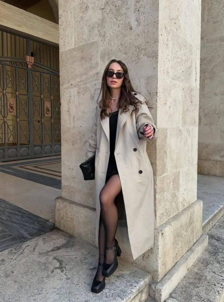 24 Beige Trench Coat Black Mini Dress Black Tights Black Mary Jane Platform Heels christmas party office outfit beige trench black dress