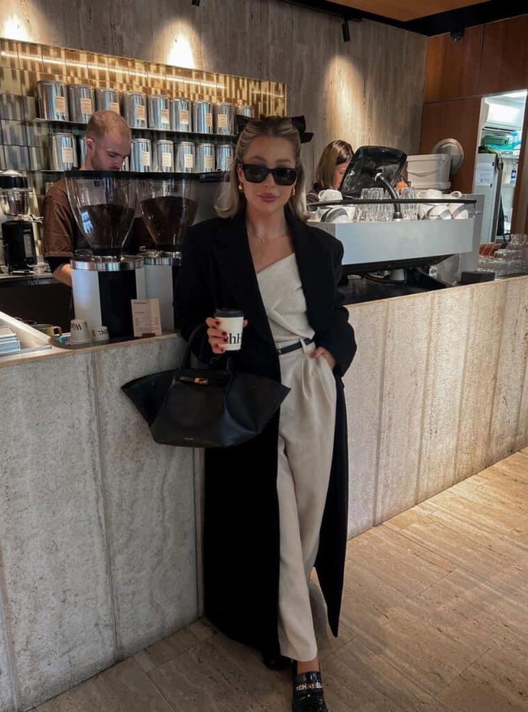 4 Black Maxi Coat Cream Knit Top Beige Trousers Black Loafers office christmas party outfit for women black coat beige pants