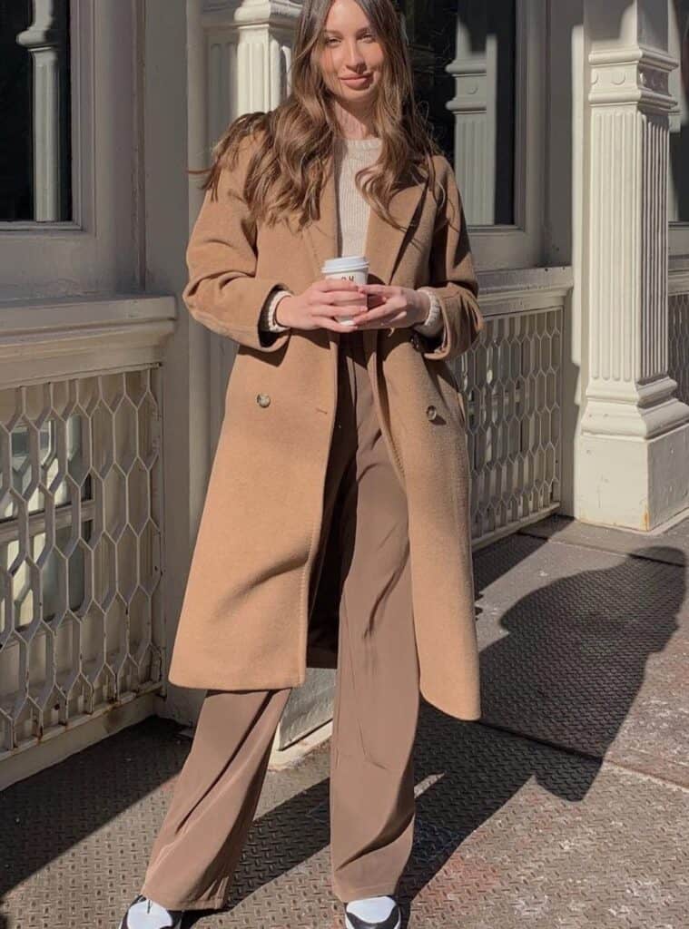 7 Camel Wool Coat Cream Knit Sweater Brown Wide Leg Trousers Black and White Sneakers christmas eve outfit ideas camel coat sweater trousers