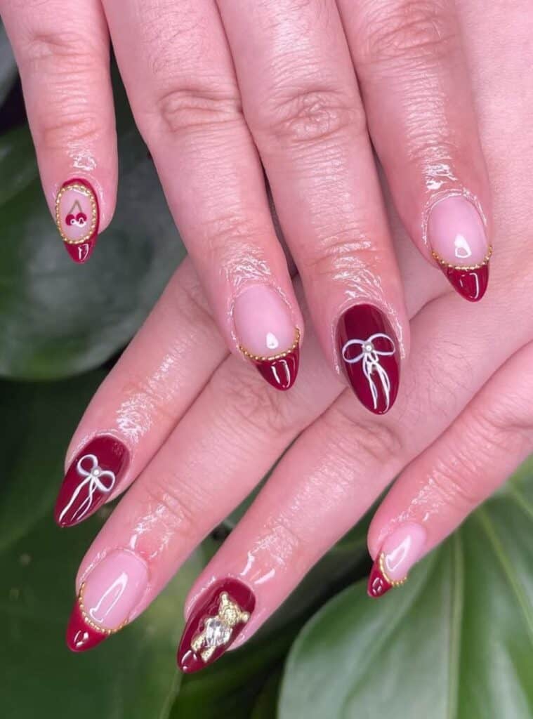 6 Deep Red Bow Accent Almond classy red almond nails with small festive bow details