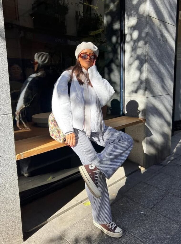 1 White Quilted Jacket Striped Wide Leg Trousers Brown Converse Sneakers european cold-weather outfits in spain with a white quilted jacket styled with striped wide-leg trousers and brown converse sneakers