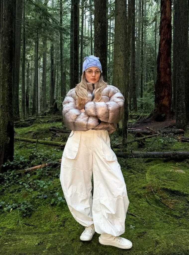 11 Metallic Taupe Cropped Puffer White Wide Leg Cargo Pants Periwinkle Graphic Beanie metallic taupe cropped puffer paired with white wide leg cargo pants and a periwinkle graphic beanie a trendy winter hiking outfit look