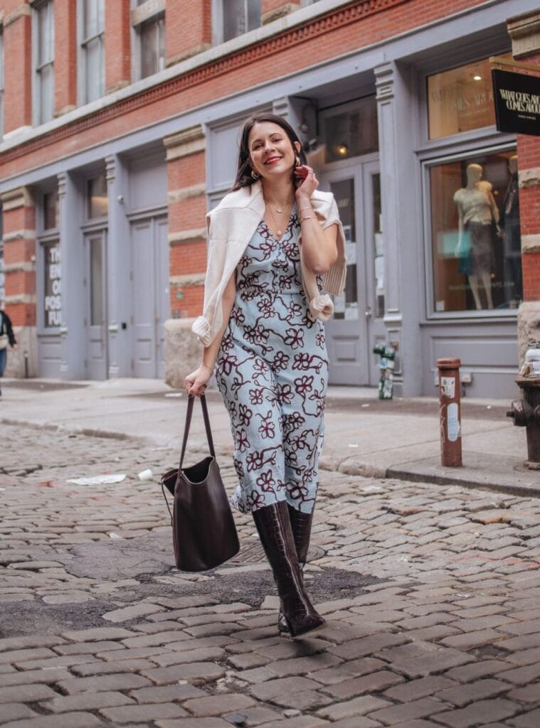 15 Blue Floral Midi White Knit Sweater Brown Boots soft winter looks in spain styled with a blue floral midi dress layered with a white knit sweater and brown boots