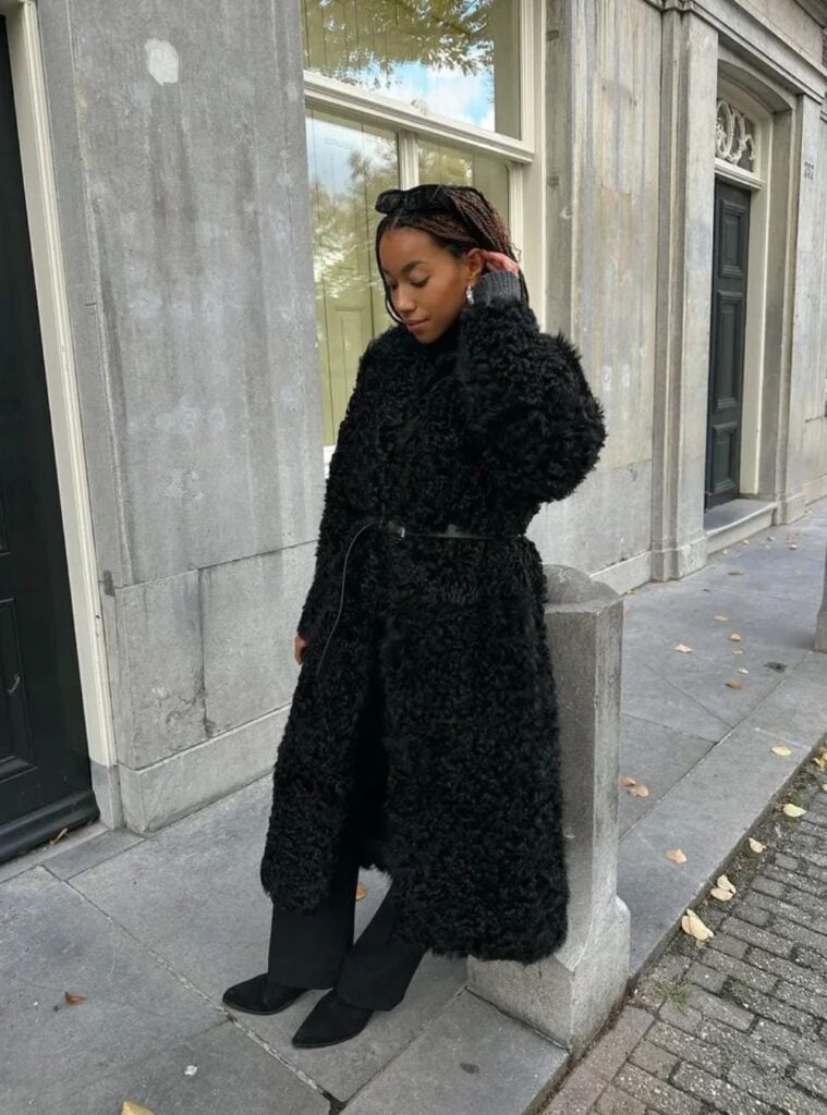 17 Jet Black Textured Coat Tailored Trousers Suede Pointed Boots sleek winter street style in spain with a jet black textured coat, tailored trousers, and suede pointed boots