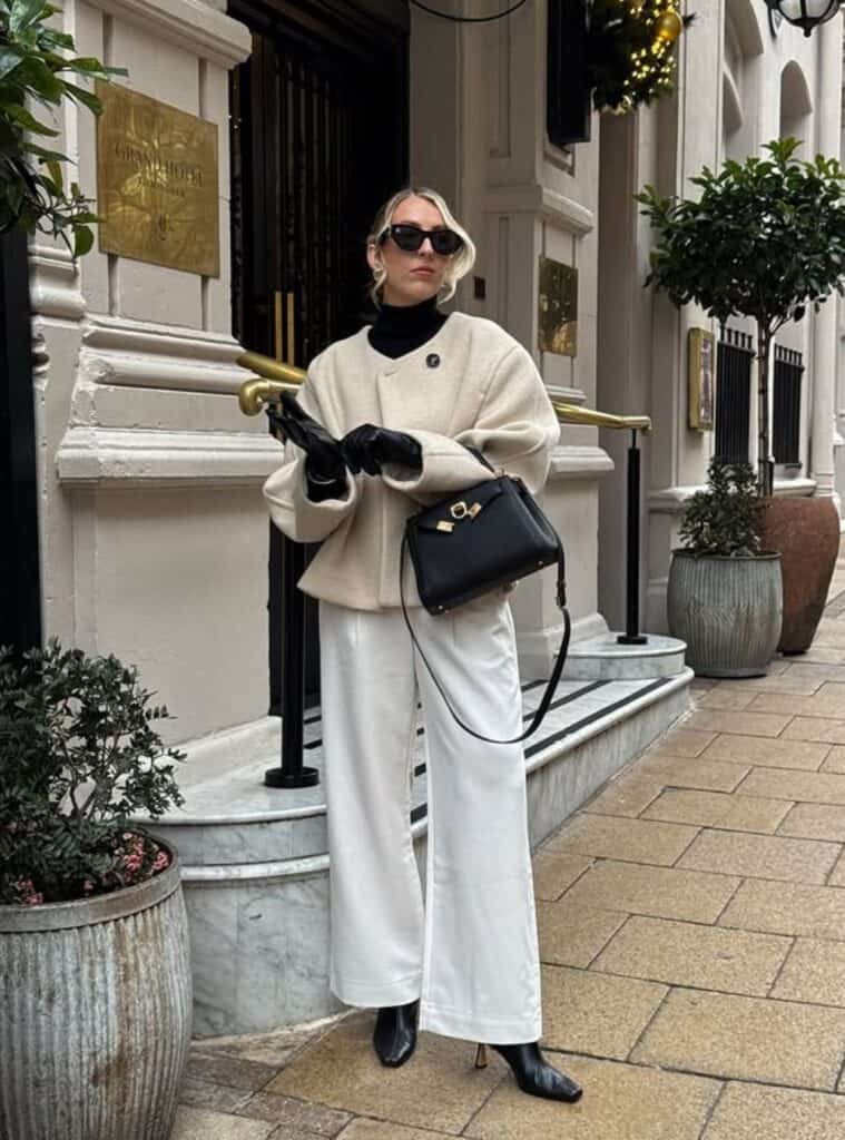 20 Cream Sculptural Jacket Black Turtleneck Ivory Wide Leg Trousers minimalist winter fashion featuring a cream sculptural jacket paired with a black turtleneck and ivory wide-leg trousers