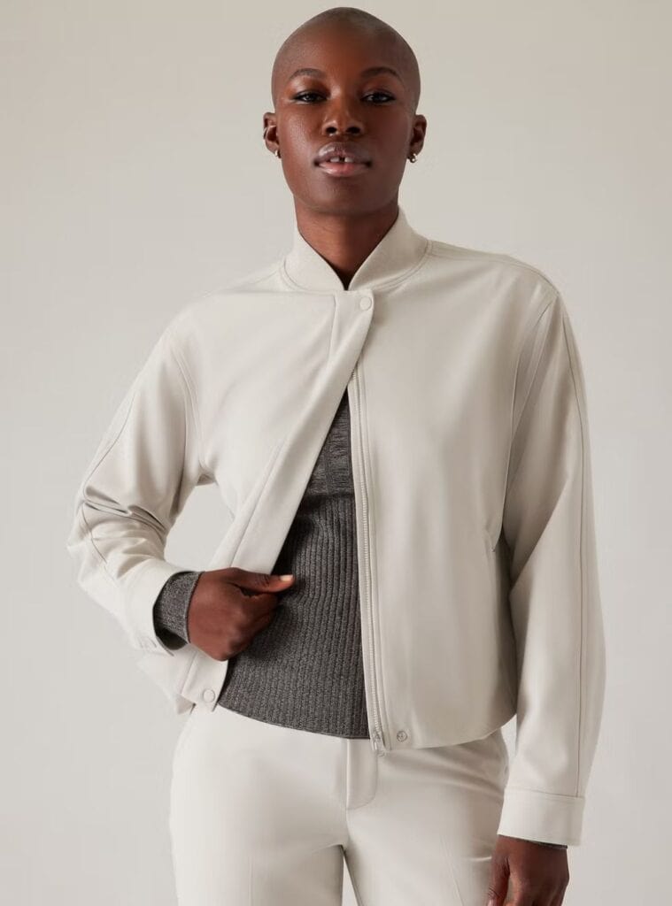 20 White Softshell Bomber Graphite Ribbed Knit Matching Tailored Trousers white softshell bomber layered over a graphite ribbed knit with matching tailored trousers a polished winter hiking outfit look