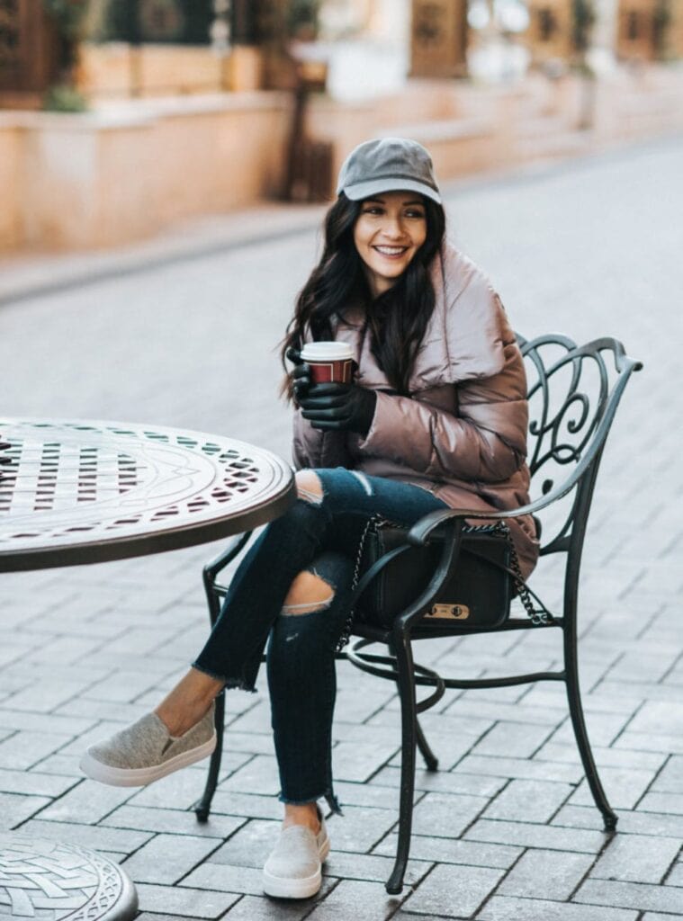 22 Brown Puffer Jacket Blue Ripped Jeans White Canvas Slip ons puffer jacket and ripped jeans styled for practical outfits for las vegas winter