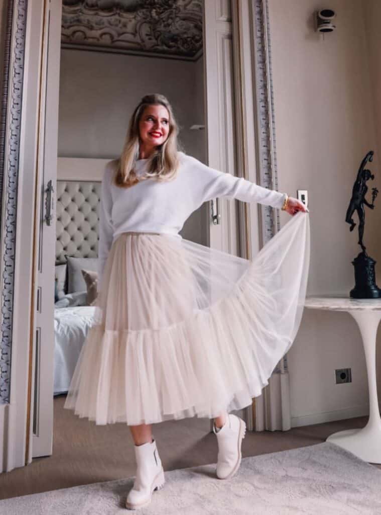 22 White Crewneck Knit Beige Tulle Midi Skirt Off White Chelsea Boots romantic winter outfits for spain featuring a white crewneck knit paired with a beige tulle midi skirt and off-white chelsea boots