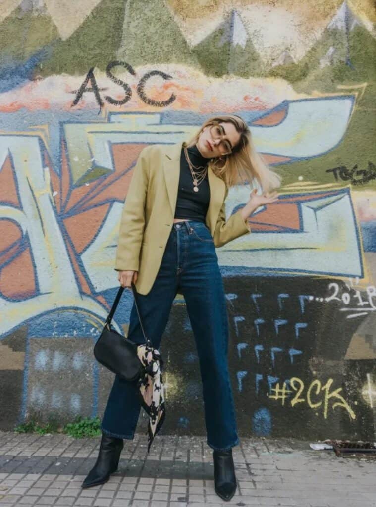 24 Chartreuse Oversized Blazer Black Mock Neck Top Dark Flare Jeans bold winter color outfits in spain with a chartreuse oversized blazer layered over a black mock-neck top and dark flare jeans