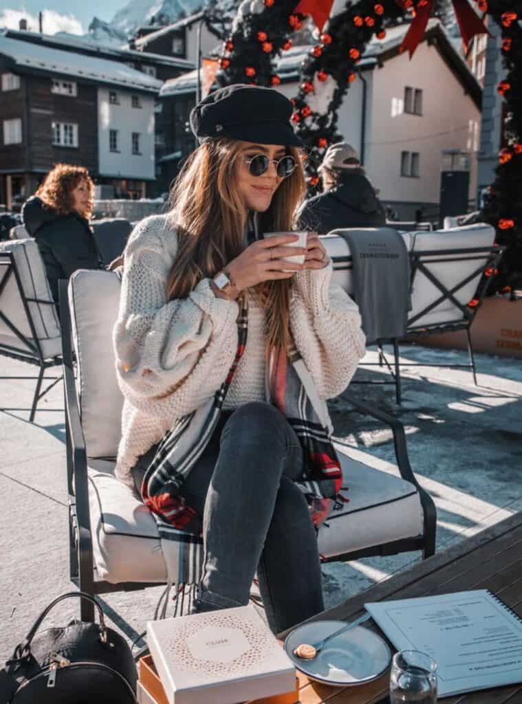 29 White Knit Sweater Distressed Light Wash Jeans Tan Platform Boots white knit sweater paired with distressed denim and platform boots for relaxed winter outfits for europe