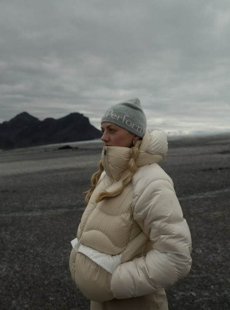 3 Cream Puffer Jacket Sand Hiking Pants Grey Logo Beanie cream puffer jacket worn with sand hiking pants and a grey logo beanie a clean and practical winter hiking outfit for women