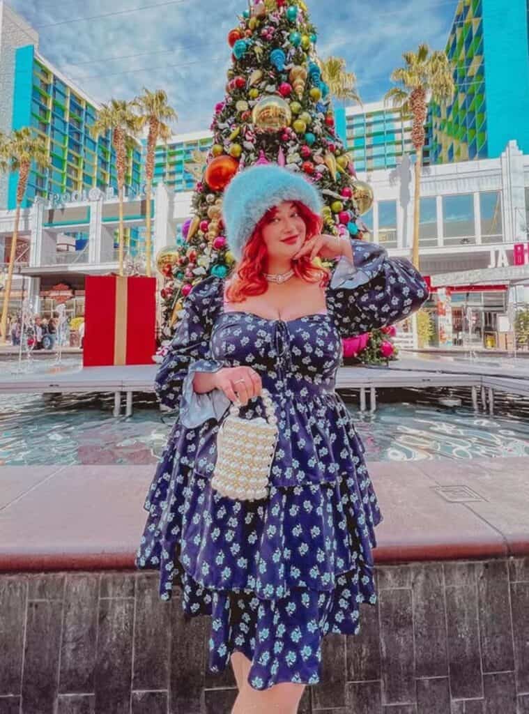 30 Midnight Floral Tiered Dress Ice Blue Fuzzy Bucket Hat White Stiletto Boots floral tiered dress styled for playful vegas winter outfits with boots