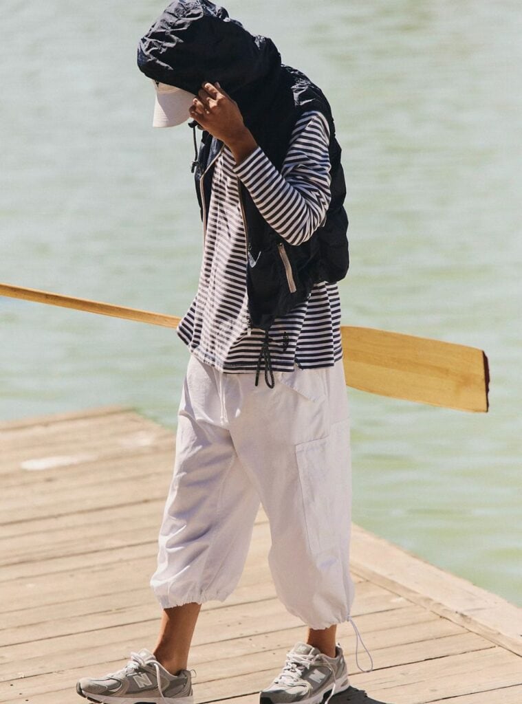 30 Navy Hooded Vest Navy Striped Long Sleeve White Oversized Cargoes navy hooded vest paired with a navy striped long sleeve and white oversized cargo pants a clean winter hiking outfit with contrast