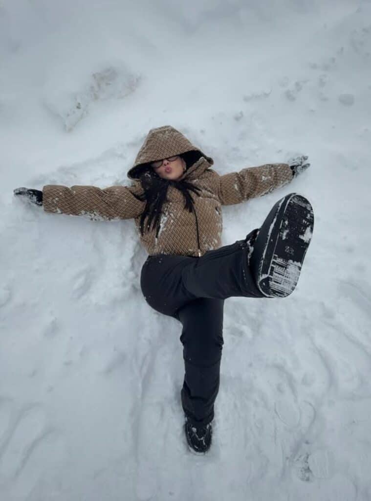 32 Brown Monogram Puffer Jacket Black Ski Pants Black Snow Boots brown monogram puffer jacket paired with ski pants and snow boots for functional switzerland winter outfits