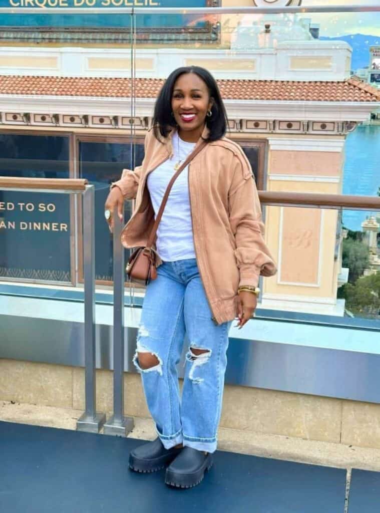 5 Tan Oversized Bomber Jacket White T Shirt Distressed Light Wash Jeans bomber jacket and distressed jeans styled for relaxed outfits for las vegas winter days