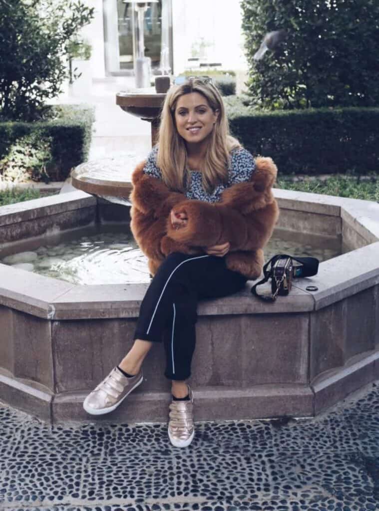 6 Brown Faux Fur Jacket Floral Print Blouse Black Trouser fashionable cold-season looks featuring a brown faux fur jacket worn with a floral print blouse and black trousers