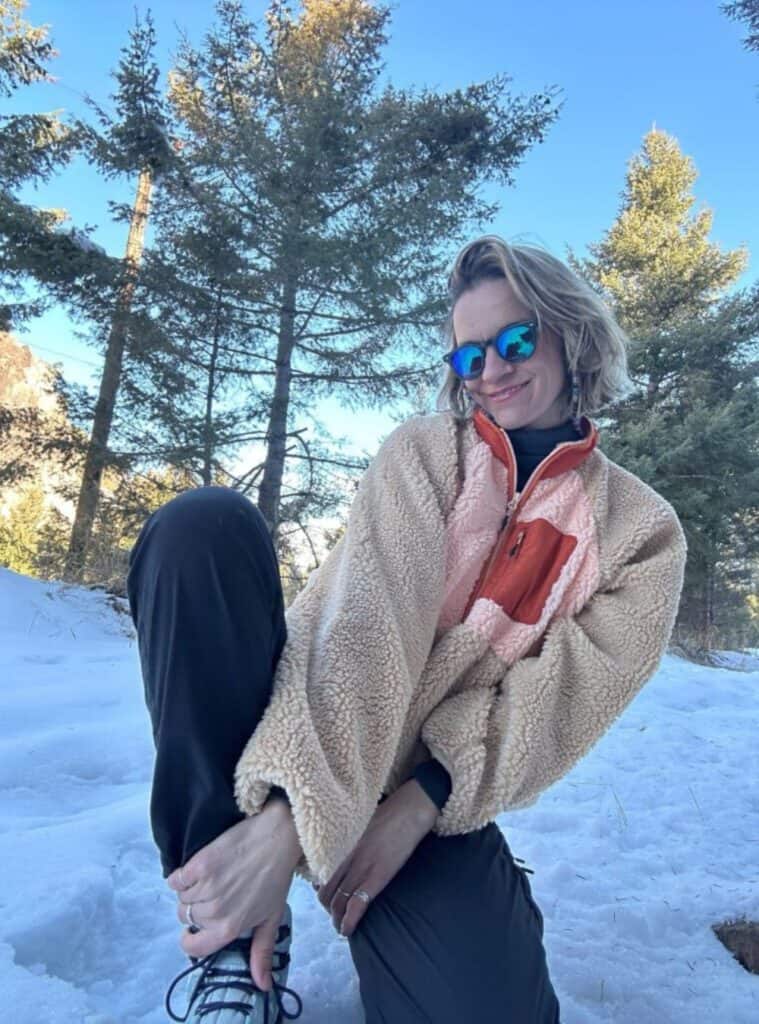 9 Tan Peach Sherpa Fleece Black Performance Leggings Teal Reflective Sunglasses tan and peach sherpa fleece worn with black performance leggings and teal reflective sunglasses a cozy winter hiking outfit with soft textures